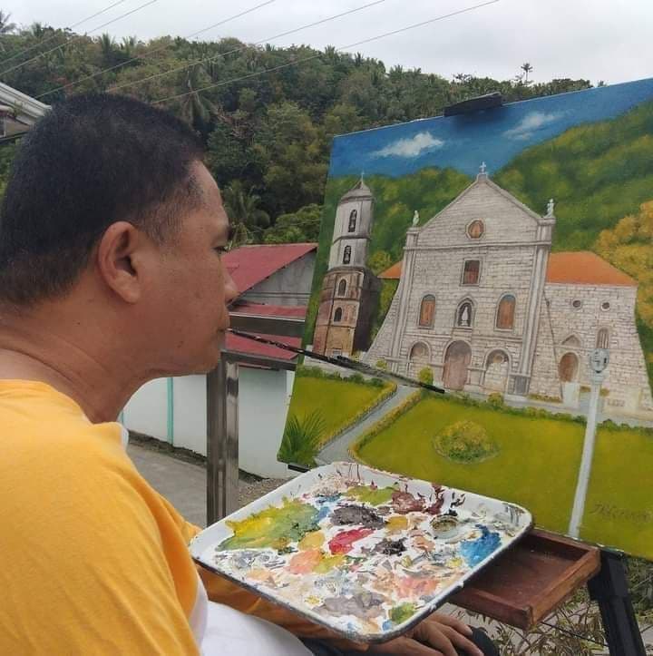 John Roland Feruelo working on a painting of Saint Joseph Cathedral